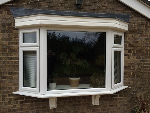Bay window with fanlights.jpg Bay window in white PVC with fanlights